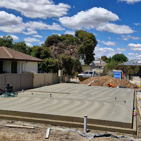 A freshly screeded rectangular slab formed up on a suburban block
