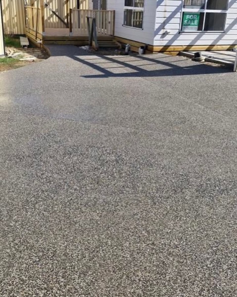 An exposed aggregate driveway with washed stone showing through the surface