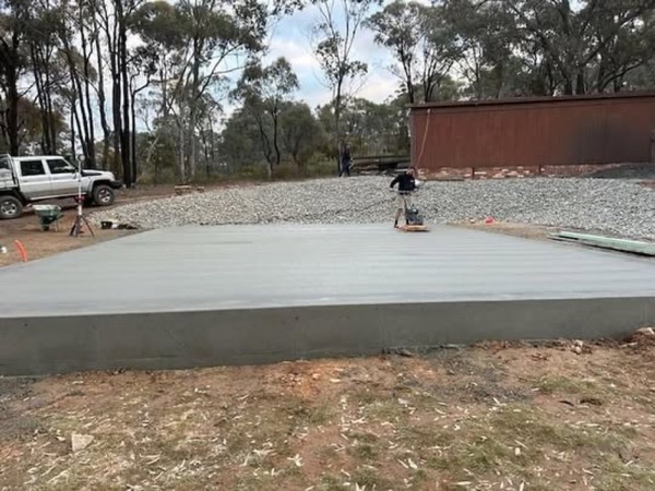 A large finished slab on a rural block with gum trees along the boundary