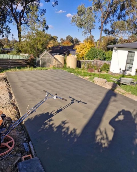 A freshly floated driveway with the surface still dark and even